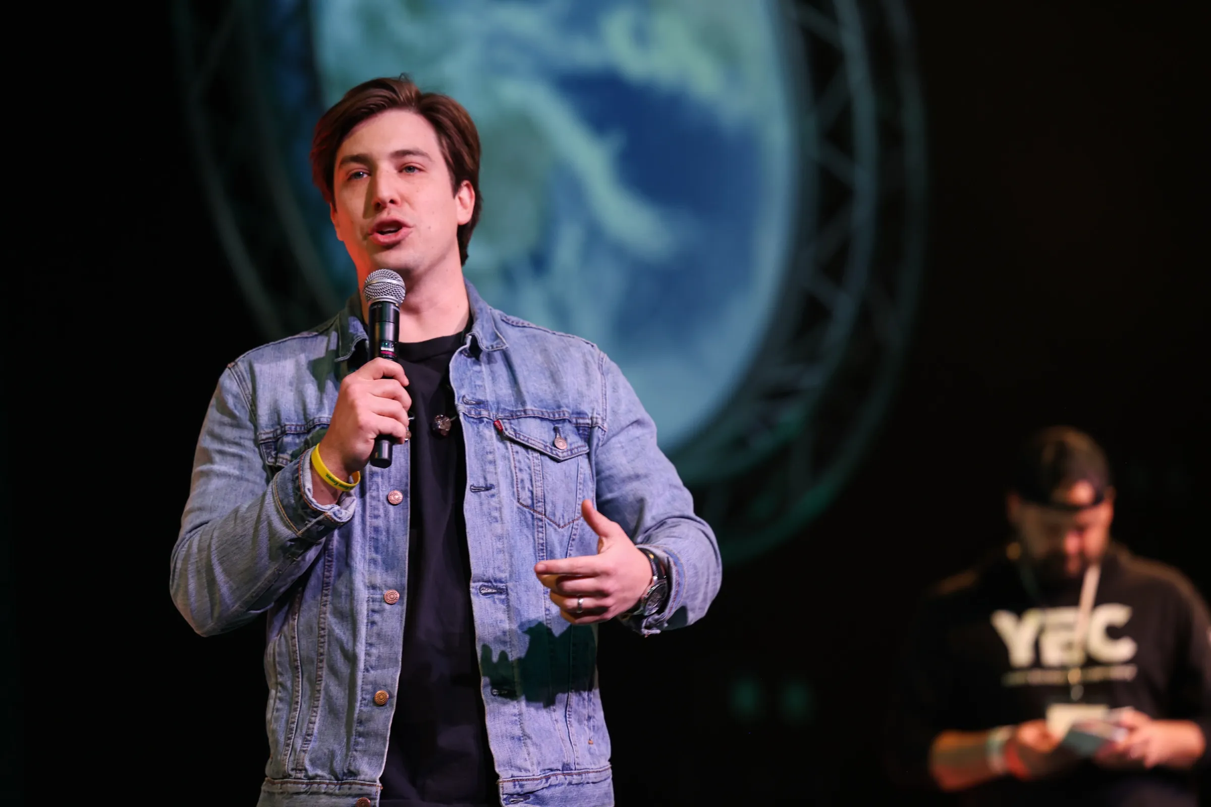 A leader teaching with a mic in hand