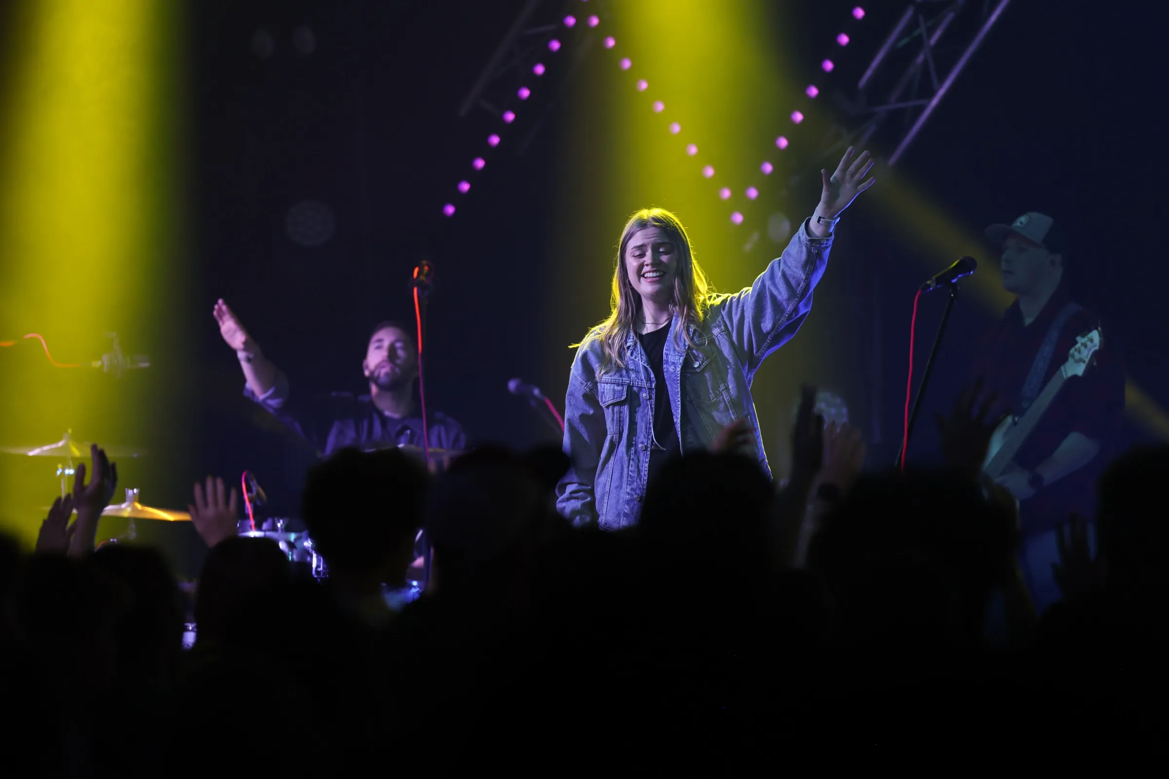A vocalist mid-song under warm light